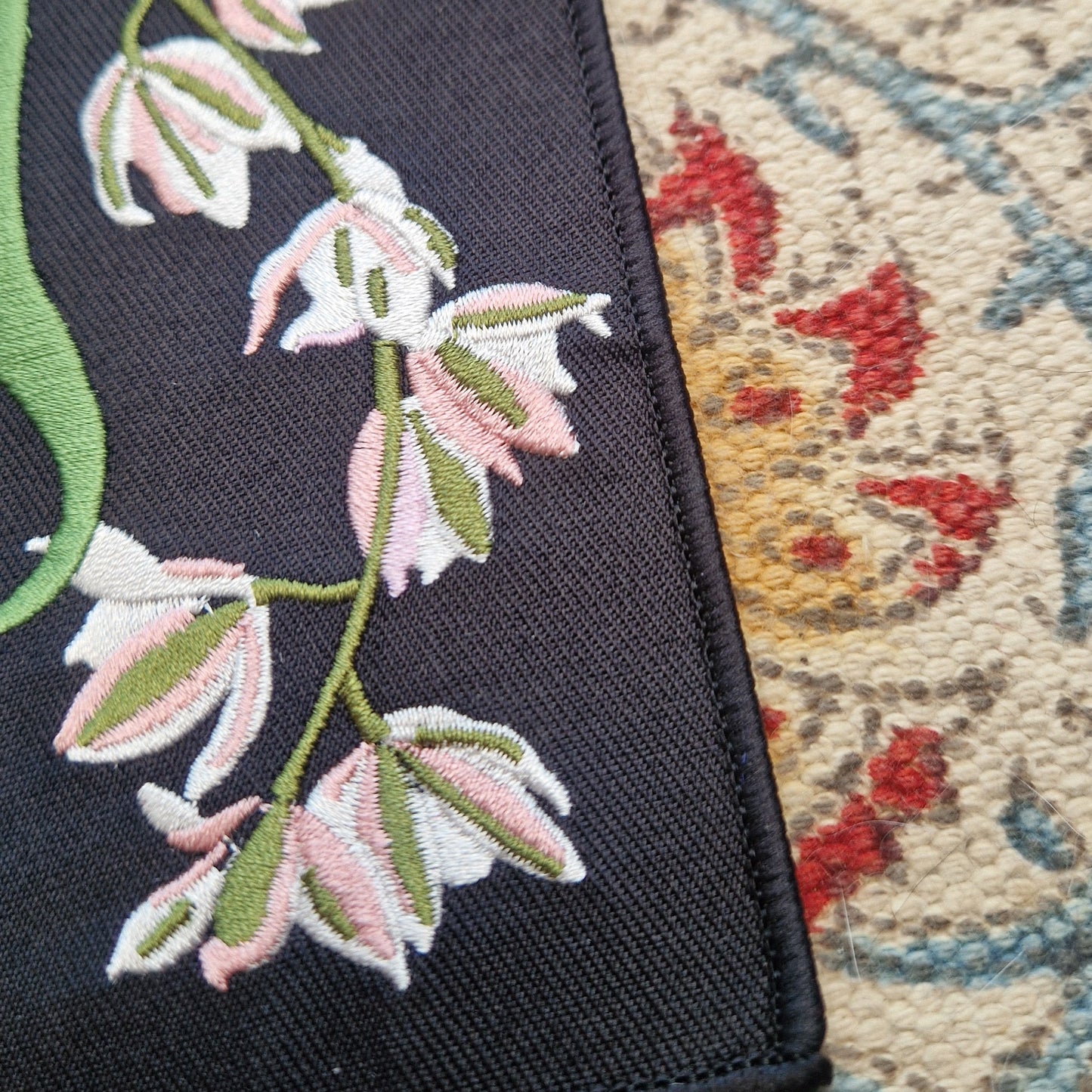 A close up of the black patch showing the colours in the orchid illustration.