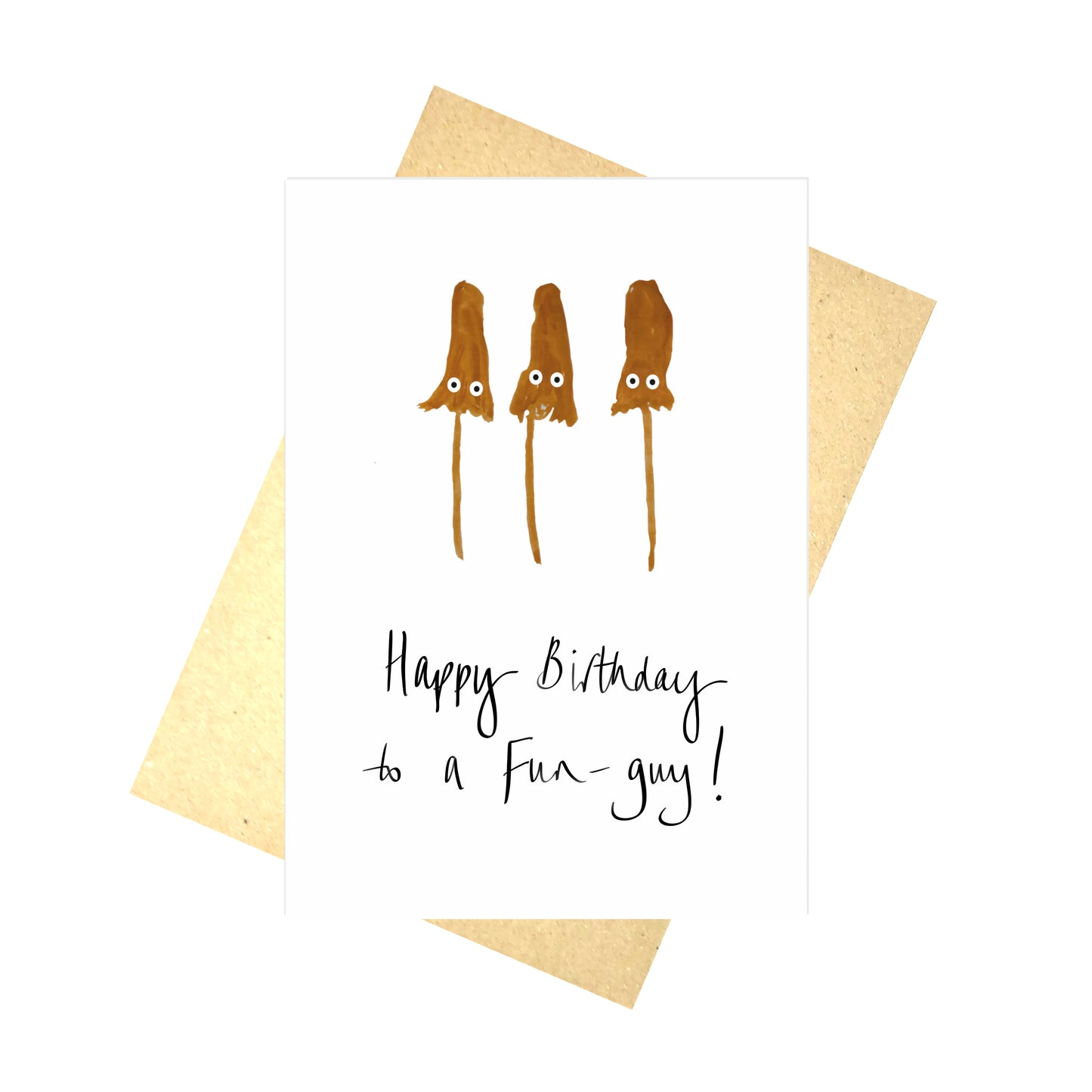 A white card with three orange fungi with cartoon eyes and the words 'Happy Birthday to a Fun-guy!' in black handwriting. Behind the card is a brown envelope as well as a white background.