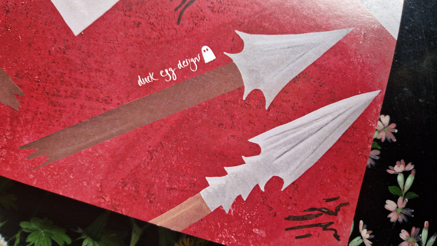 Illustration of two stylized white arrowheads on brown shafts with a small ghost, plus handwritten text “duck egg design” on red—perfect for campaign notes in your Reckless Attack Notebook by Duck Egg Designs.